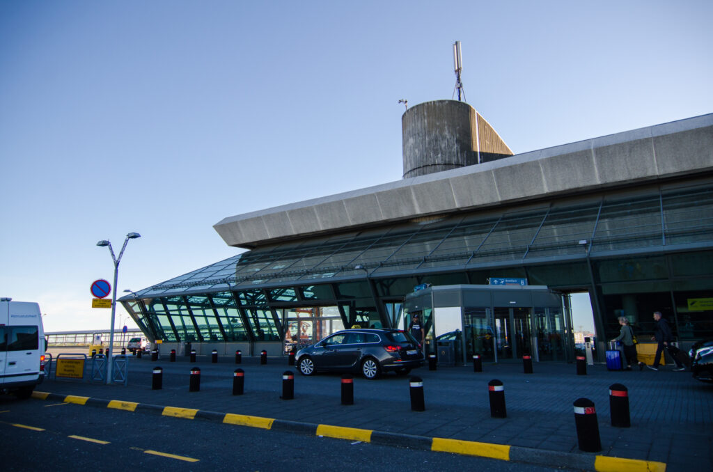 Ibiza Airport arrivals area with passengers and ground transport services